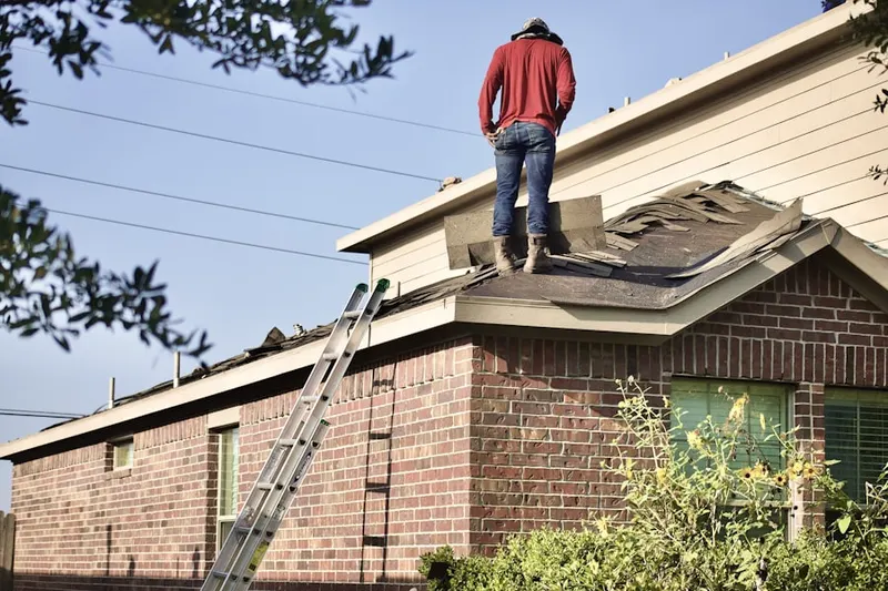 Professional roofer working on a residential roof in Harbor Village